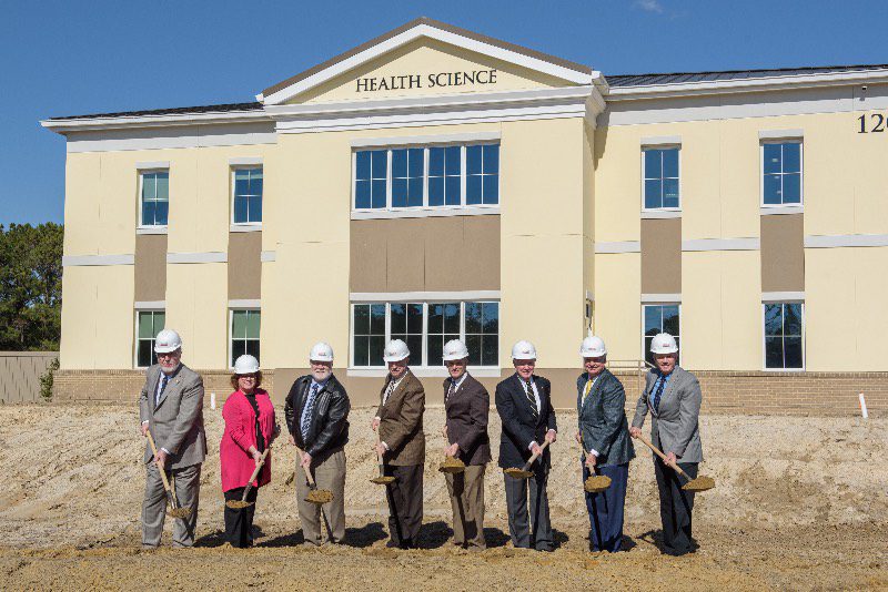 CSU board of trustees in front of health science building. Charleston Southern breaks ground on new physical therapy wing.