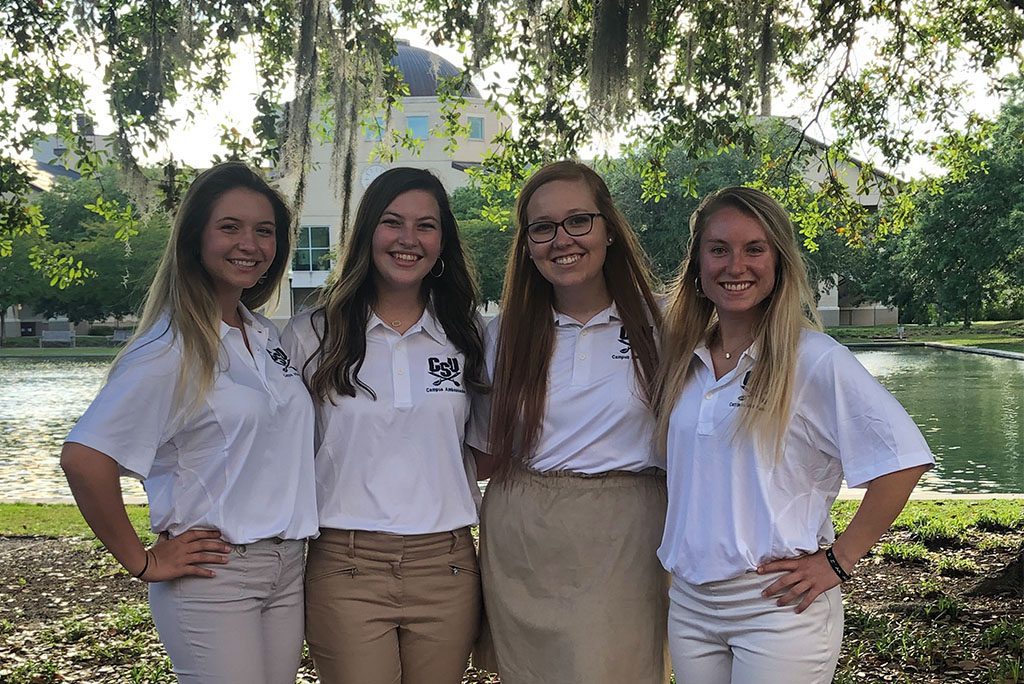 campus ambassadors smile for a picture by CSU's reflection pond.